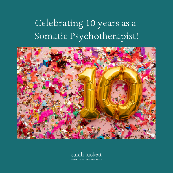 Photograph of gold helium balloons of the number 10 lying on a background of colourful sparkly glitter. The image title reads: Celebrating 10 years as a somatic psychotherapist – Sarah Tuckett Somatic Psychotherapist
